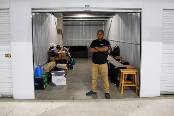 A man standing in the threshold of a storage unit 