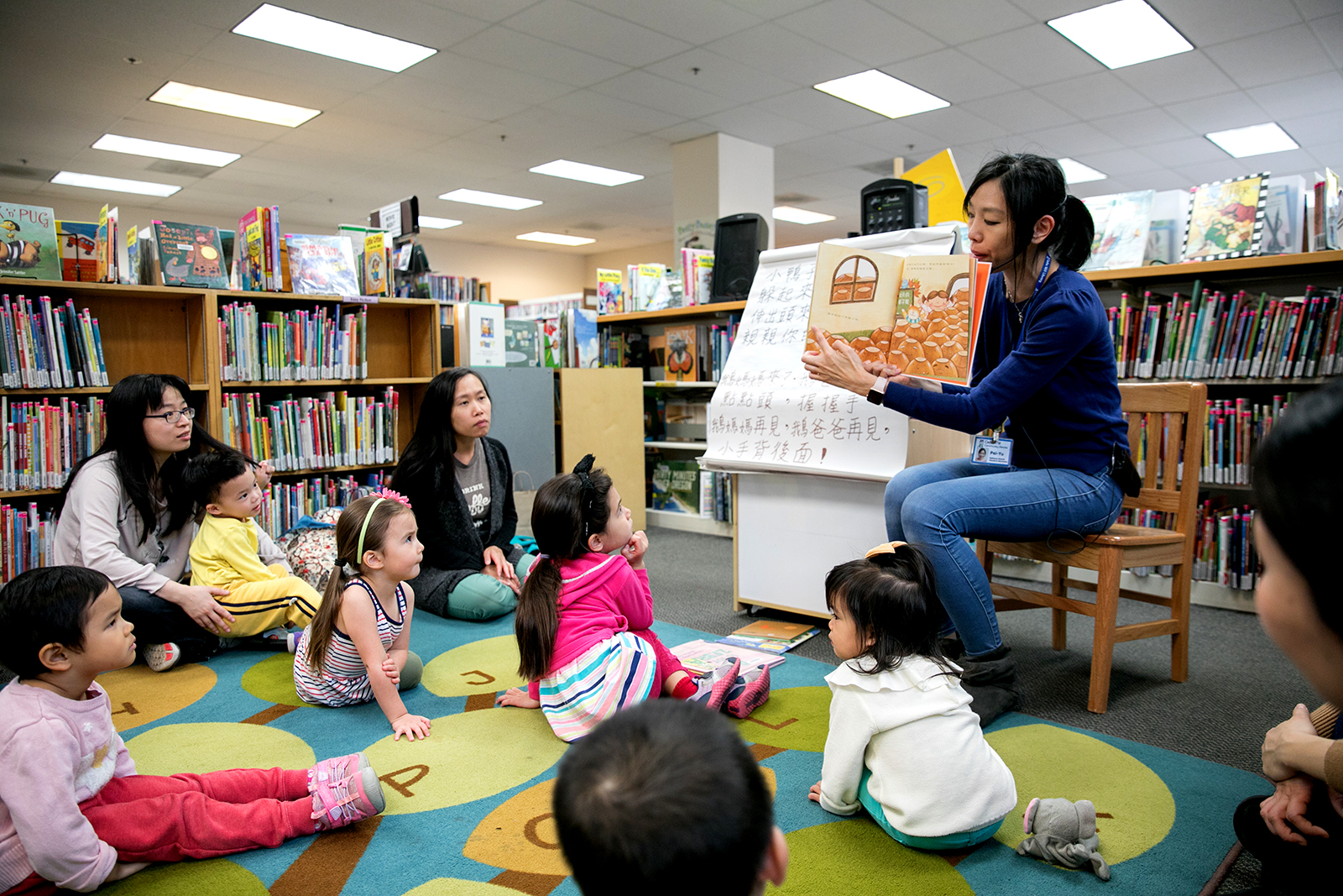 Instructor reading to children and parents for Mandarin Story Time