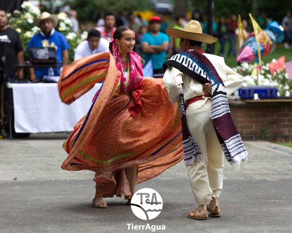 Two dancers in traditional pueblos originarios garb dance at La Guelaguetza.