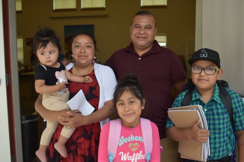 ​Bienstar family poses for a photo and the Back-to-School fair