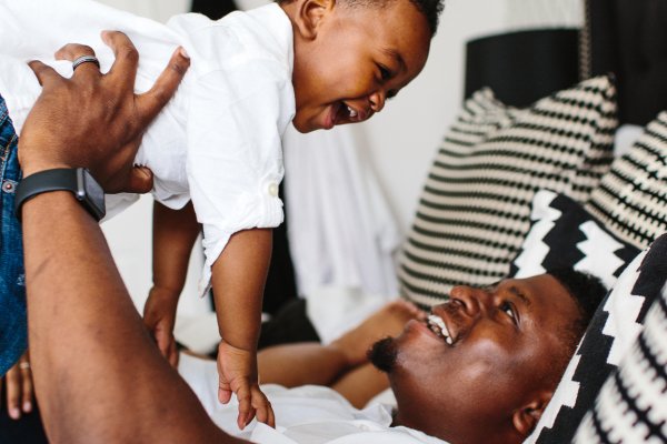 A man holds a smiling baby