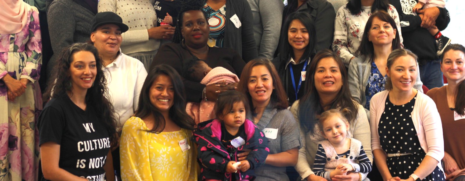 A group of parents and children pose for a photo