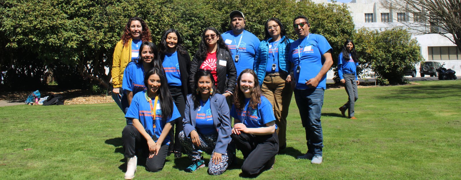 A group poses in front of the ORegon State Capitol Building wearing Community Resilience Hubs t-shirts