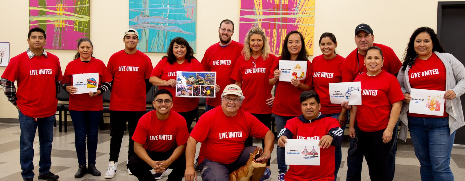 A group of adults in red United Way t-shirts pose for a photo
