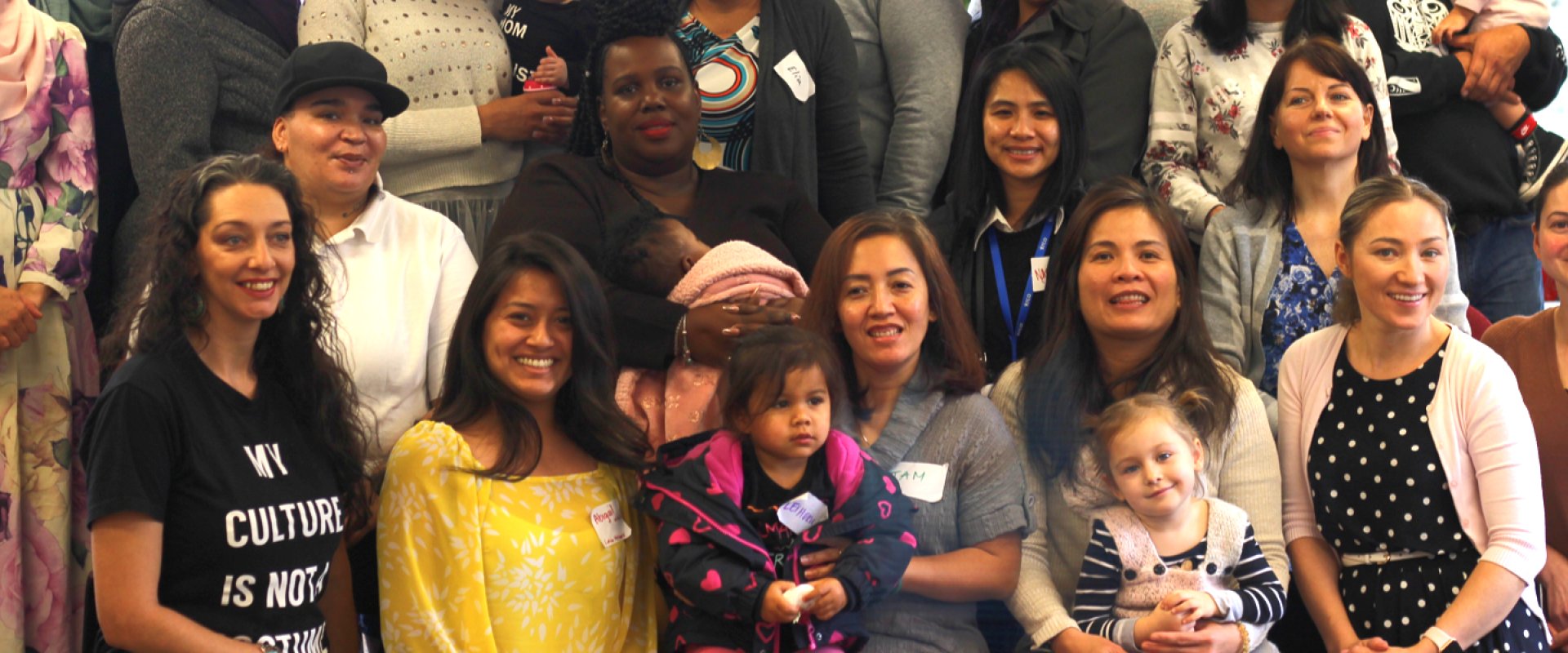 A group of parents and children pose for a photo