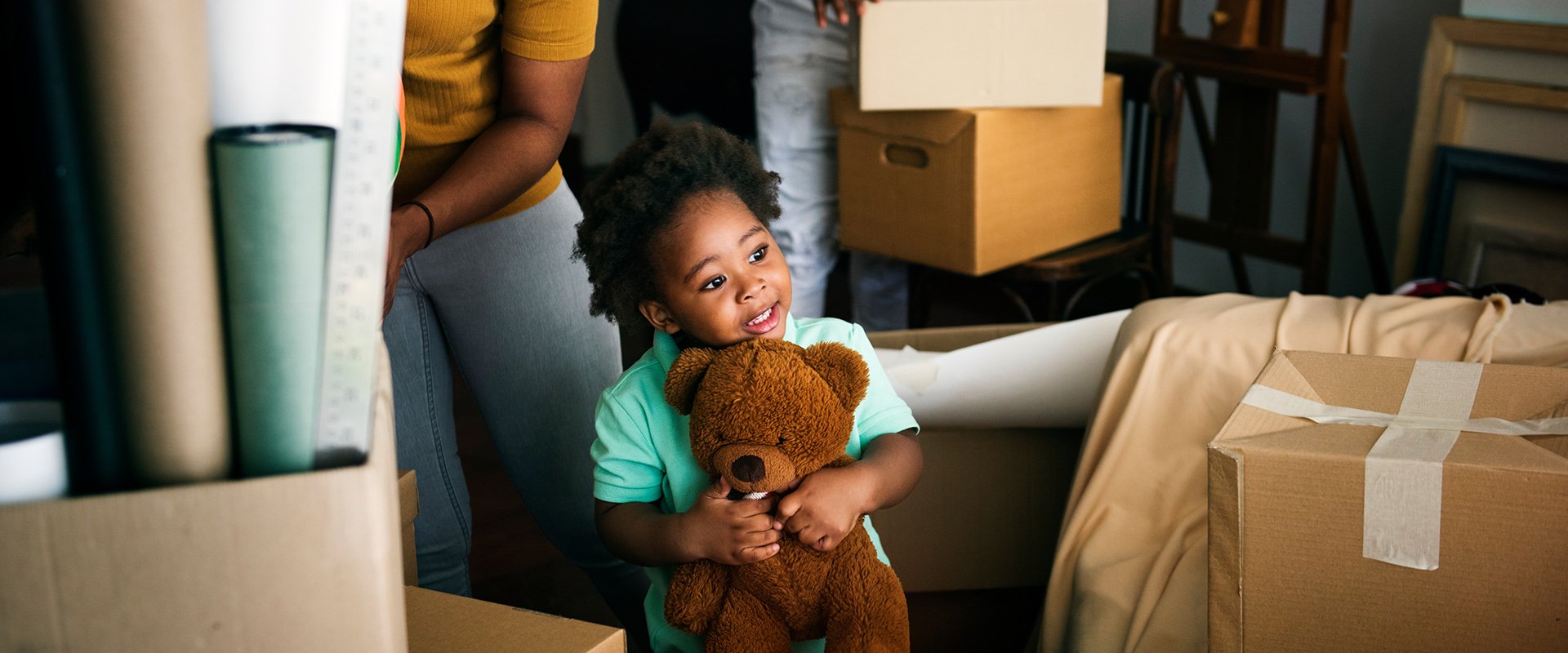 A little girl holds a teddy bear