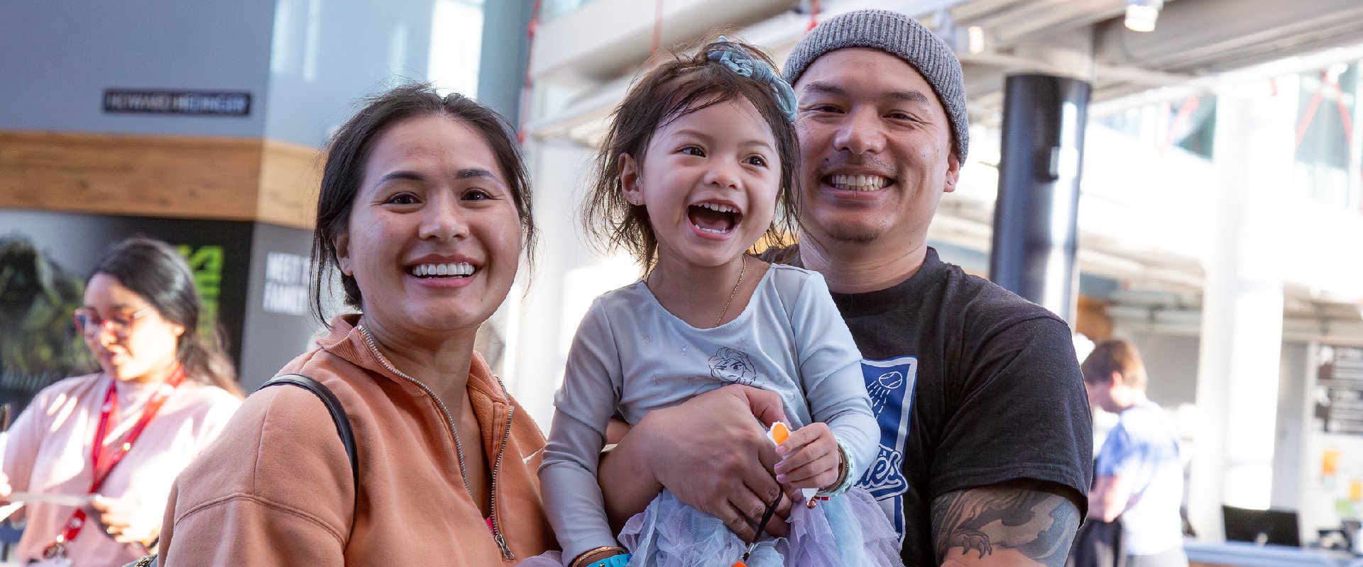 A family of three smile for the camera