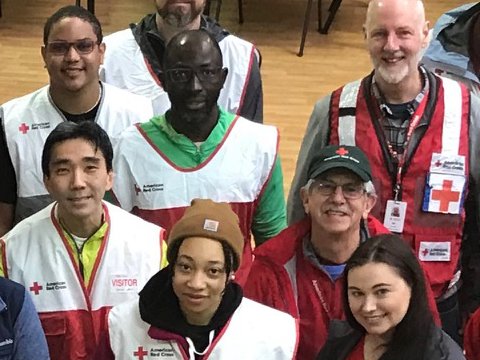 men and women in vests