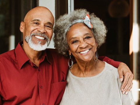 An older couple smiles