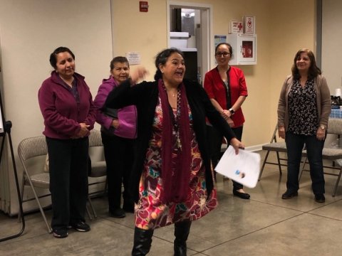 A woman gives a fiery speech to a group of individuals