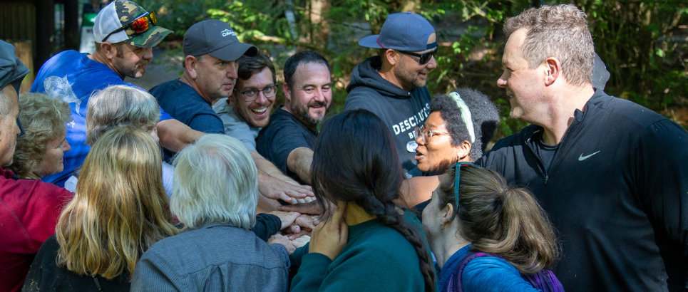 a group of people put their hands in to cheer