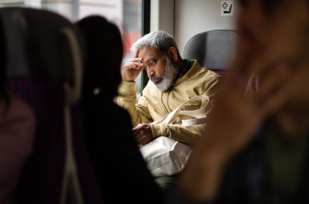 A man sits on a bus contemplating