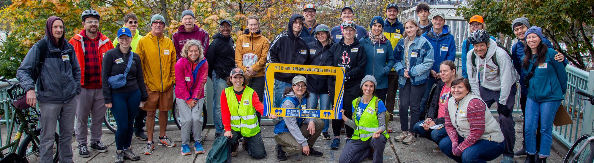 A group of volunteers stand smiling 