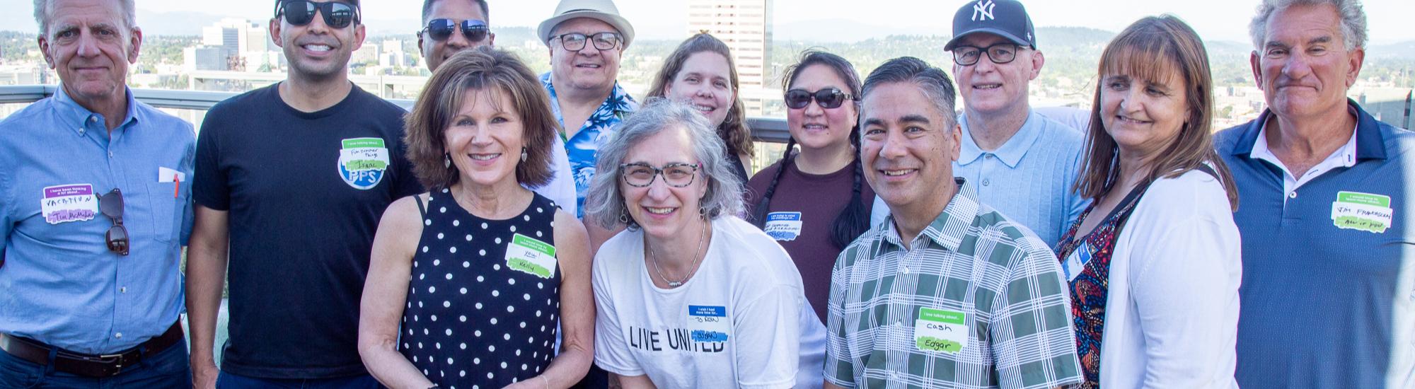 A large group of people smile in a group