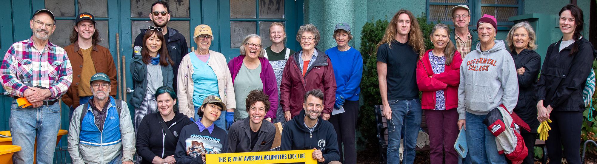 A large group of people smile in a group, many wearing United Way branded shirts