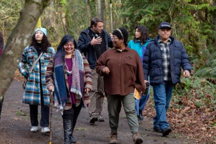 a group of people walking along a path talking