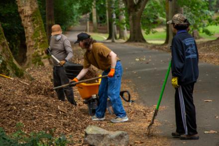 three people work in a park