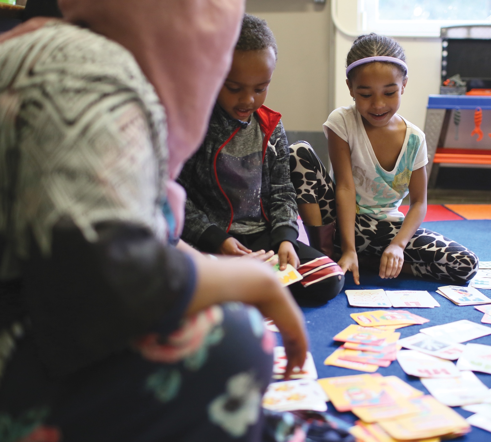 Preschoolers at CAIRO academy looking at flash cards